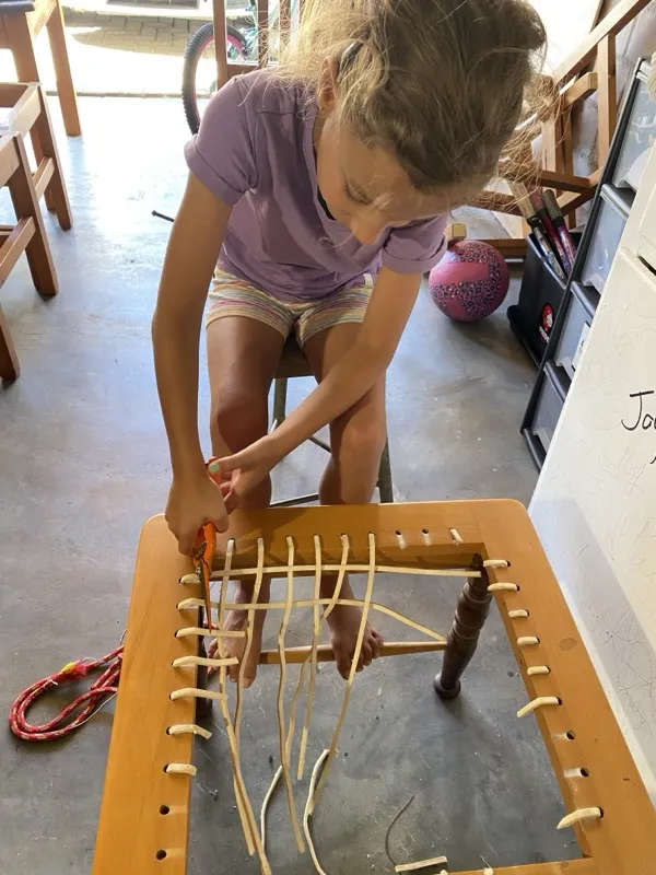 Maia working on riempie weaving