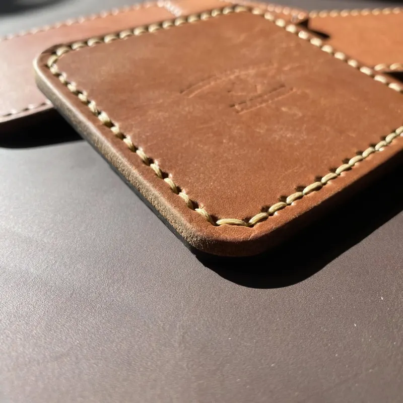 Hand-stitched leather coaster detail